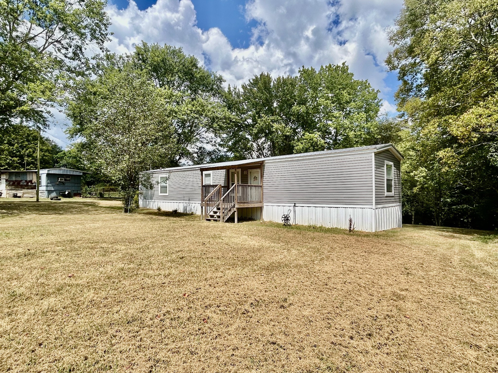 1359 Charley Davis Road Goodspring, TN 38460 - Photo 1 of 24 a backyard of a house with large trees