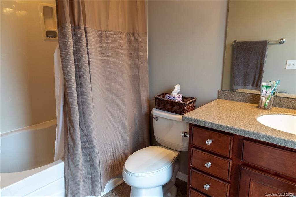 564 6th Baxter Crossing, Unit 13 Fort Mill, SC 29708 - Photo 11 of 39 a bathroom with a granite countertop toilet sink and a mirror