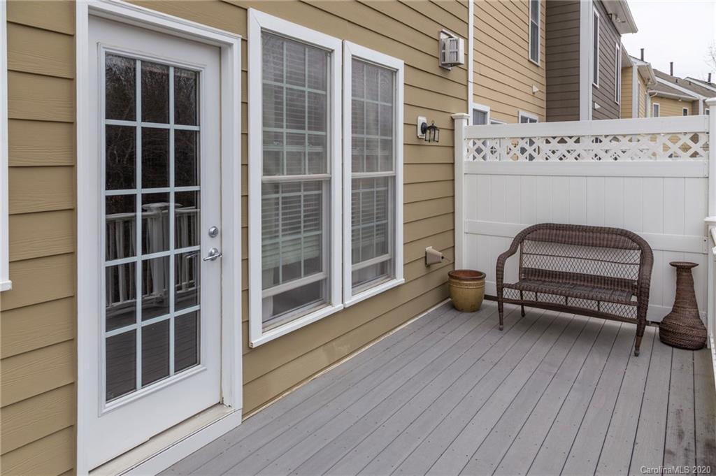 564 6th Baxter Crossing, Unit 13 Fort Mill, SC 29708 - Photo 19 of 39 a view of a balcony with wooden floor and a potted plant