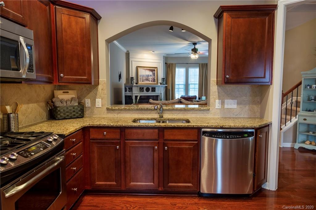 564 6th Baxter Crossing, Unit 13 Fort Mill, SC 29708 - Photo 5 of 39 a kitchen with granite countertop a stove and a sink