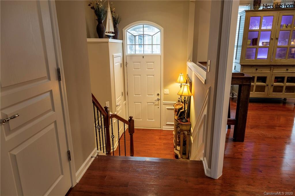 564 6th Baxter Crossing, Unit 13 Fort Mill, SC 29708 - Photo 7 of 39 a view of a hallway with wooden floor windows and a livingroom