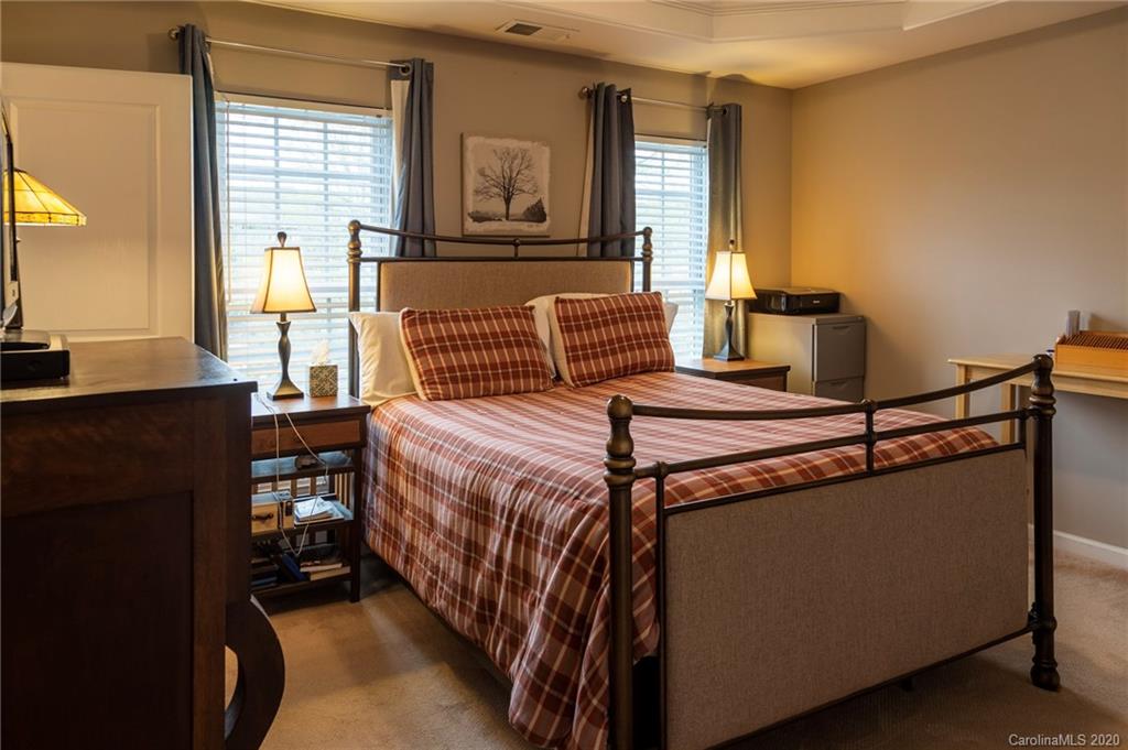 564 6th Baxter Crossing, Unit 13 Fort Mill, SC 29708 - Photo 8 of 39 a bedroom with a bed and wooden floor