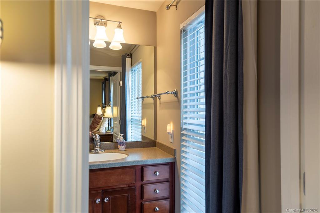 564 6th Baxter Crossing, Unit 13 Fort Mill, SC 29708 - Photo 10 of 39 a bathroom with a granite countertop sink and a mirror