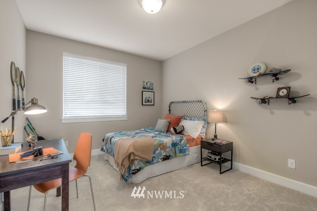 1428 241st (11) Place Southeast Bothell, WA 98021 - Photo 19 of 21 a bedroom with a bed and a table in it