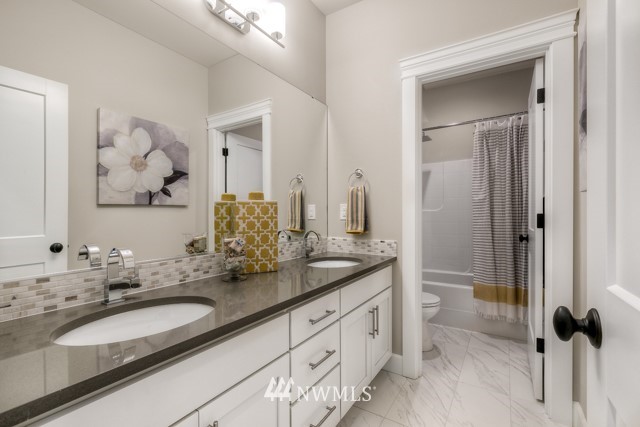 1428 241st (11) Place Southeast Bothell, WA 98021 - Photo 21 of 21 a bathroom with a double vanity sink and mirror