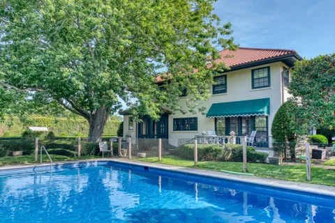 a front view of house with yard and outdoor seating