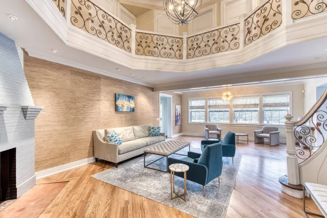 a living room with furniture and a chandelier