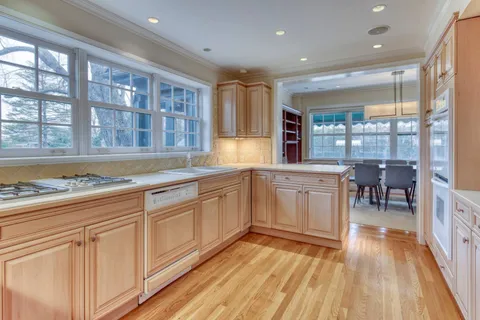 a kitchen with sink cabinets and wooden floor