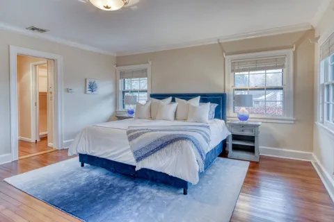 a bedroom with a bed and wooden floor