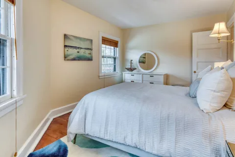 a bedroom with a bed and a painting on the wall