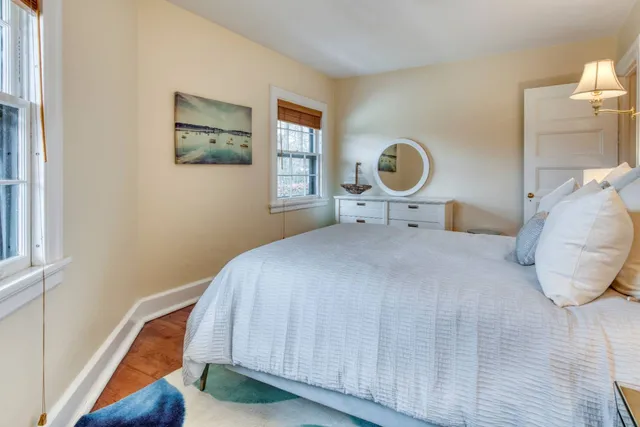 a bedroom with a bed and a painting on the wall