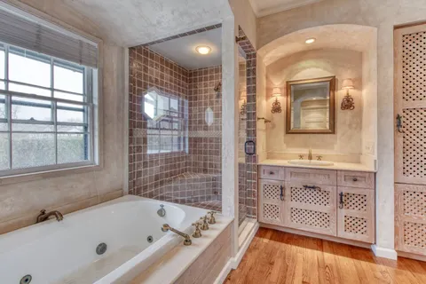 a bathroom with a bathtub a sink and a shower