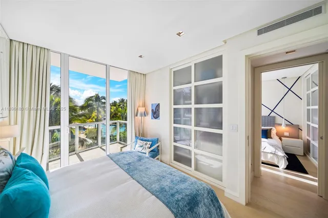 a bedroom with a bed and a view of living room