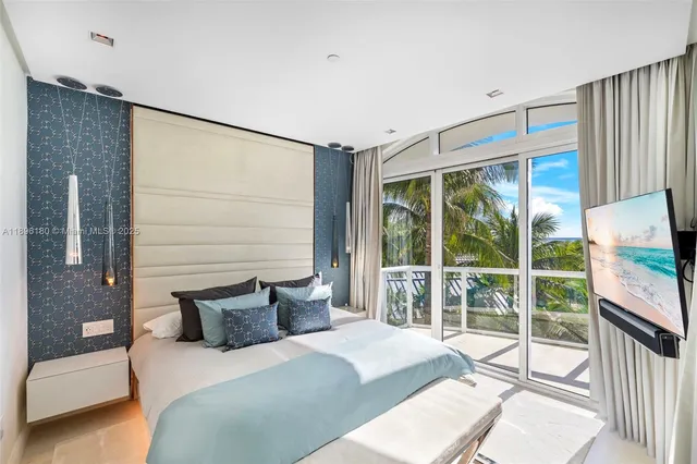 a bedroom with a bed and glass door
