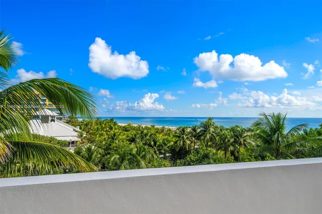 a view of a balcony with flower plants