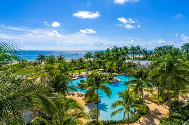 a view of a yard with wooden fence