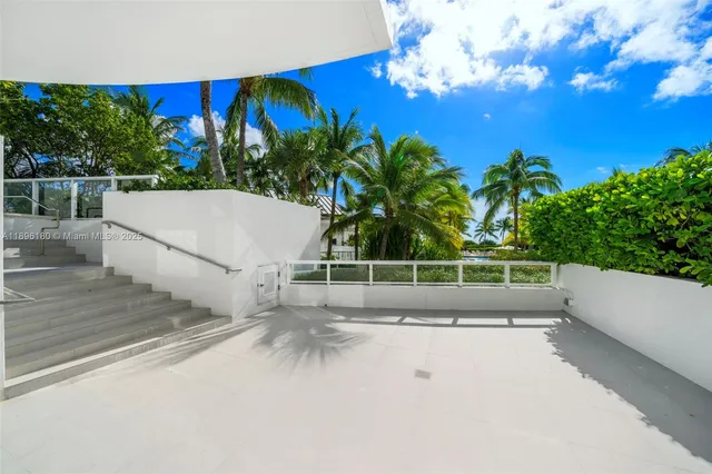 a view of a palm tree with flower plants