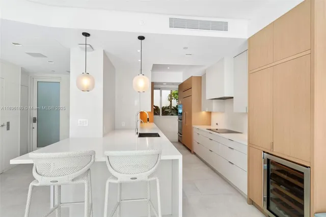 a kitchen with a sink cabinets and wooden floor