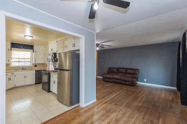 a kitchen with a refrigerator and a stove top oven