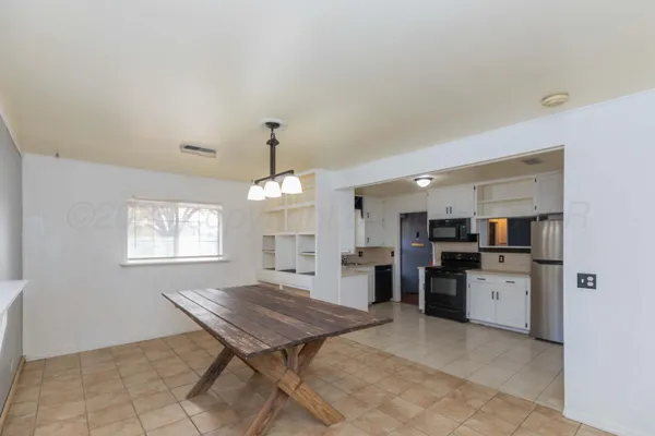 a open kitchen with refrigerator stove and kitchen island