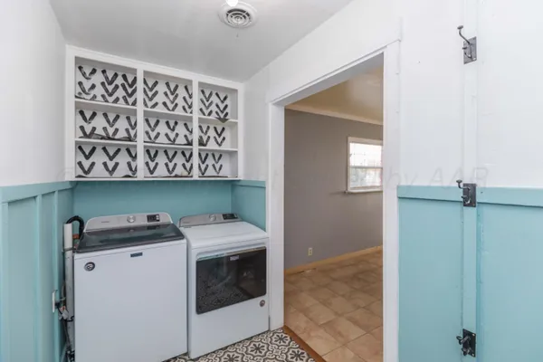a utility room with sink dryer and washer