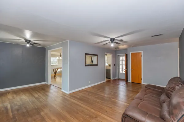 a view of livingroom with hardwood floor and ceiling fan