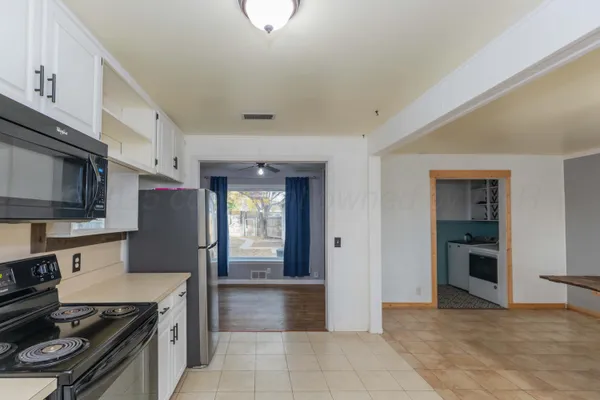 a kitchen with stainless steel appliances granite countertop a refrigerator stove and sink