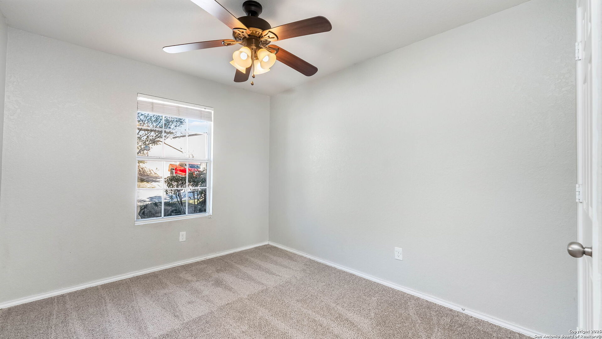 7690 Paraiso Boerne, TX 78015 - Photo 11 of 24 an empty room with a window and a fan