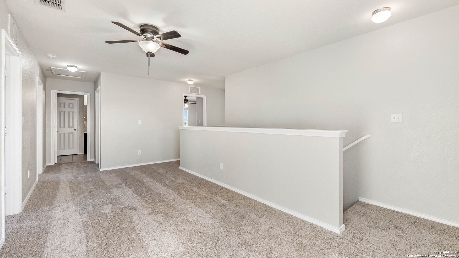 7690 Paraiso Boerne, TX 78015 - Photo 12 of 24 wooden floor in an empty room with a chandelier fan