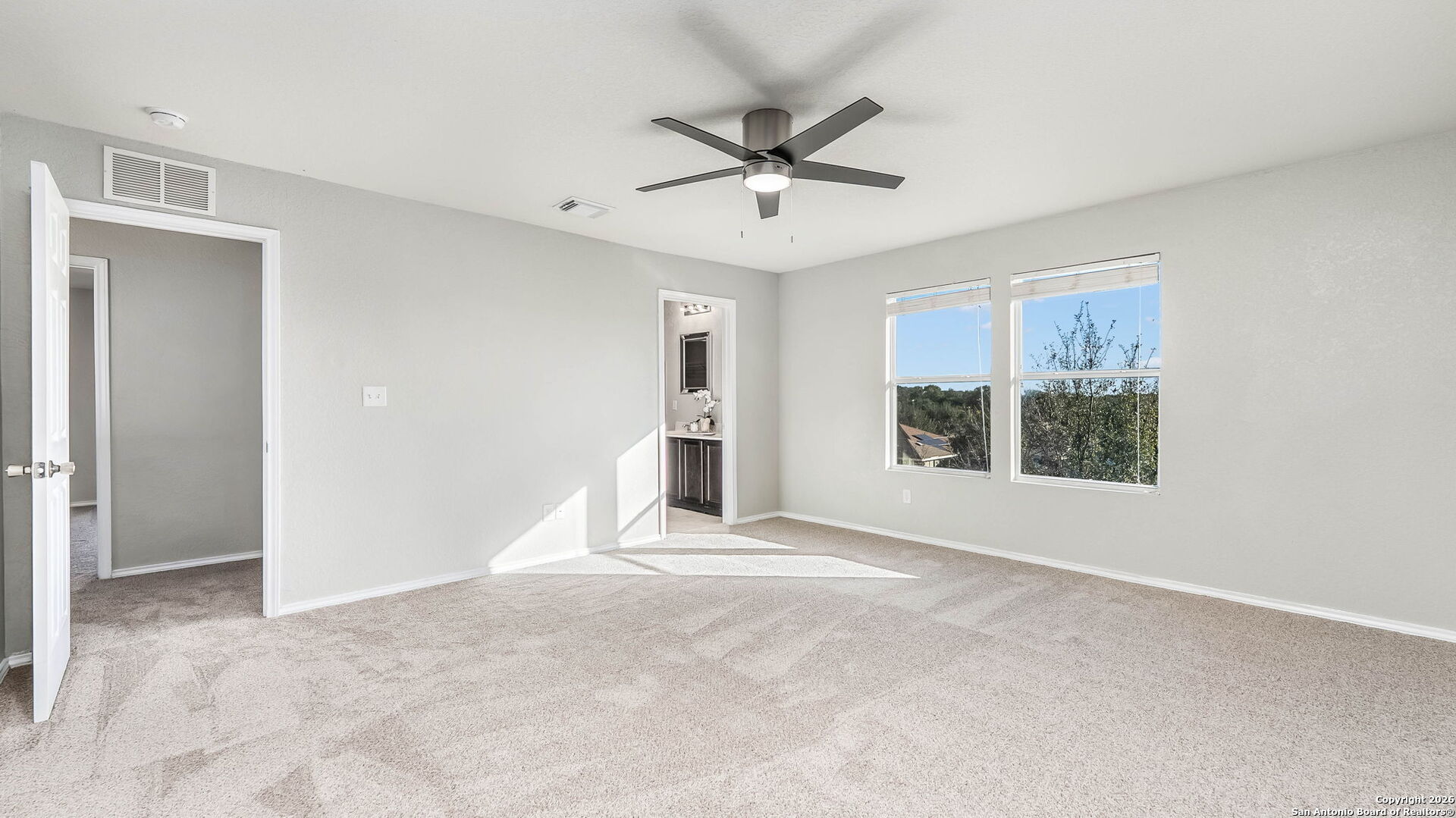 7690 Paraiso Boerne, TX 78015 - Photo 12 of 21 a view of a livingroom with a ceiling fan and windows