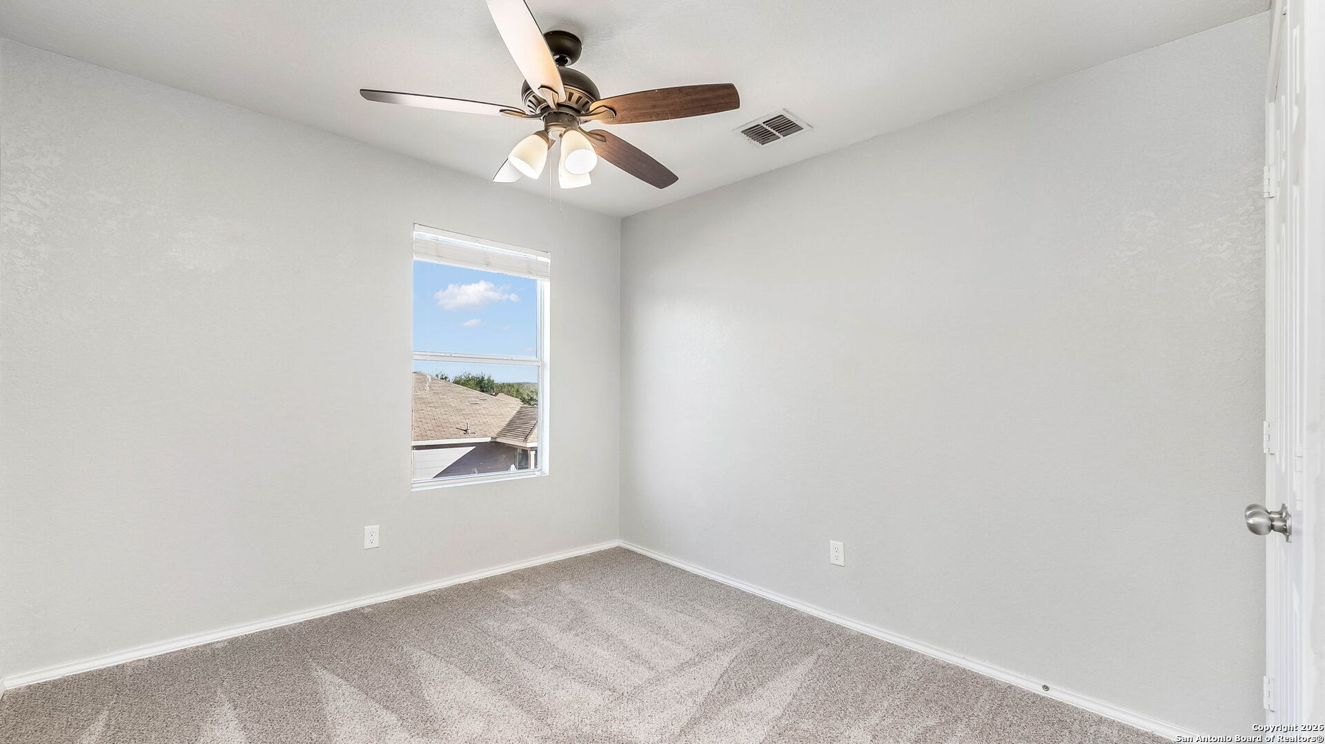 7690 Paraiso Boerne, TX 78015 - Photo 16 of 21 an empty room with window and fan