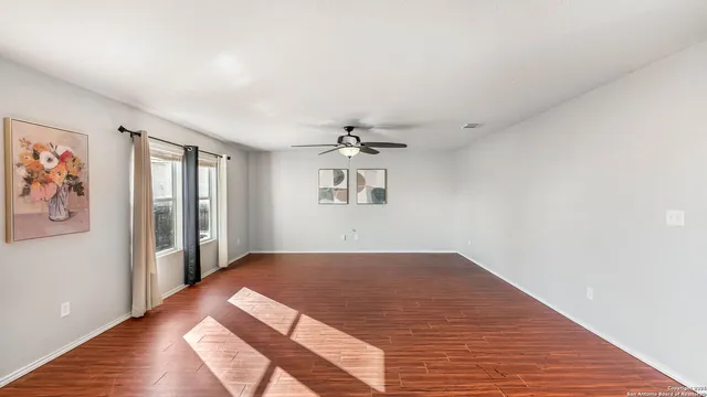 wooden floor in a room next to a window