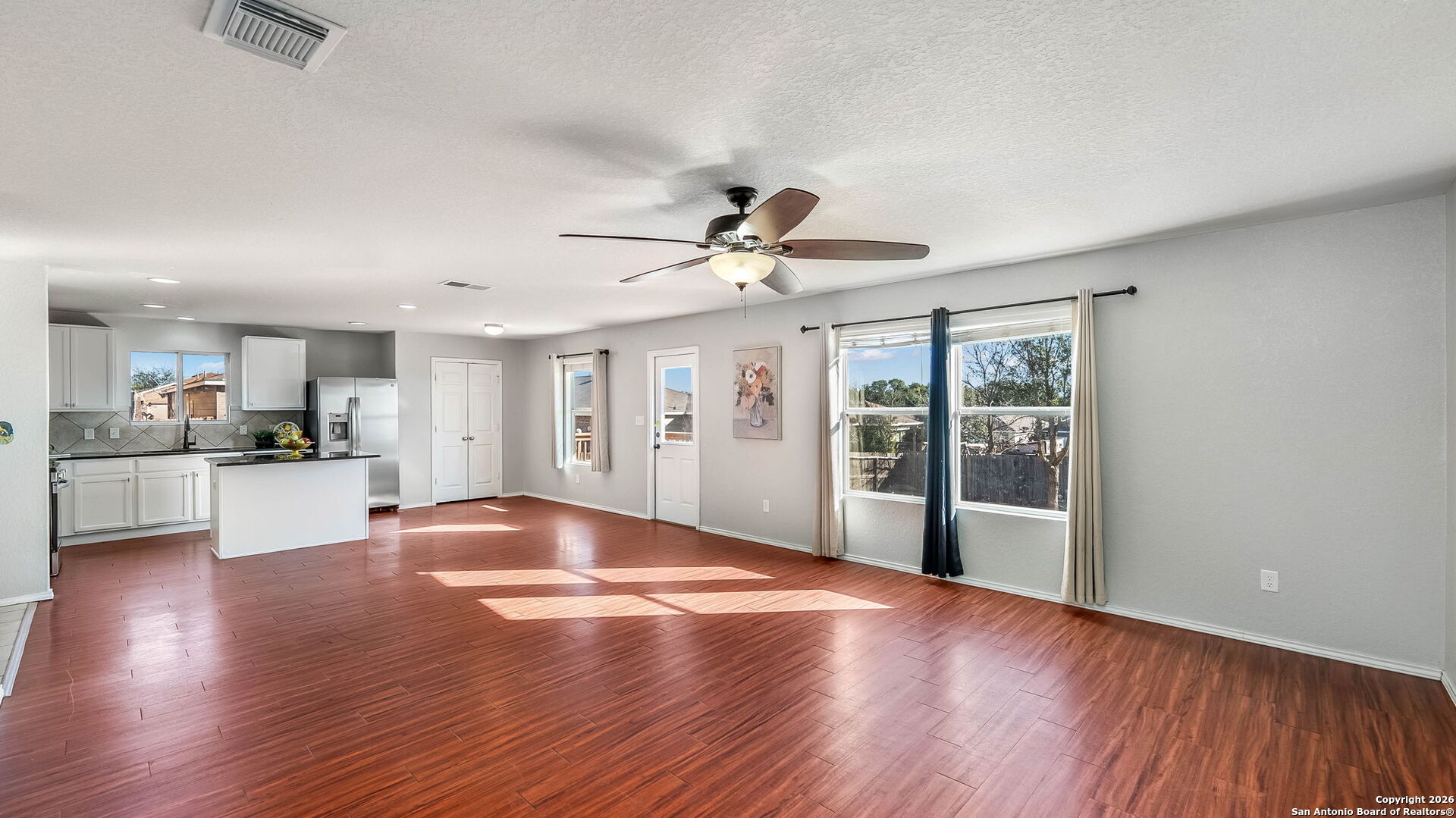 7690 Paraiso Boerne, TX 78015 - Photo 5 of 24 a view of an empty room with window and wooden floor
