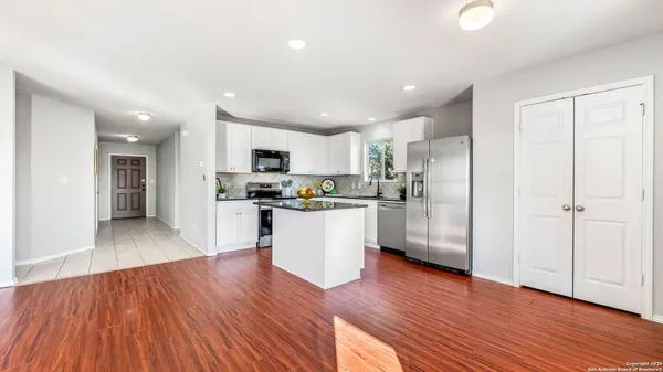 a kitchen with a refrigerator and a sink