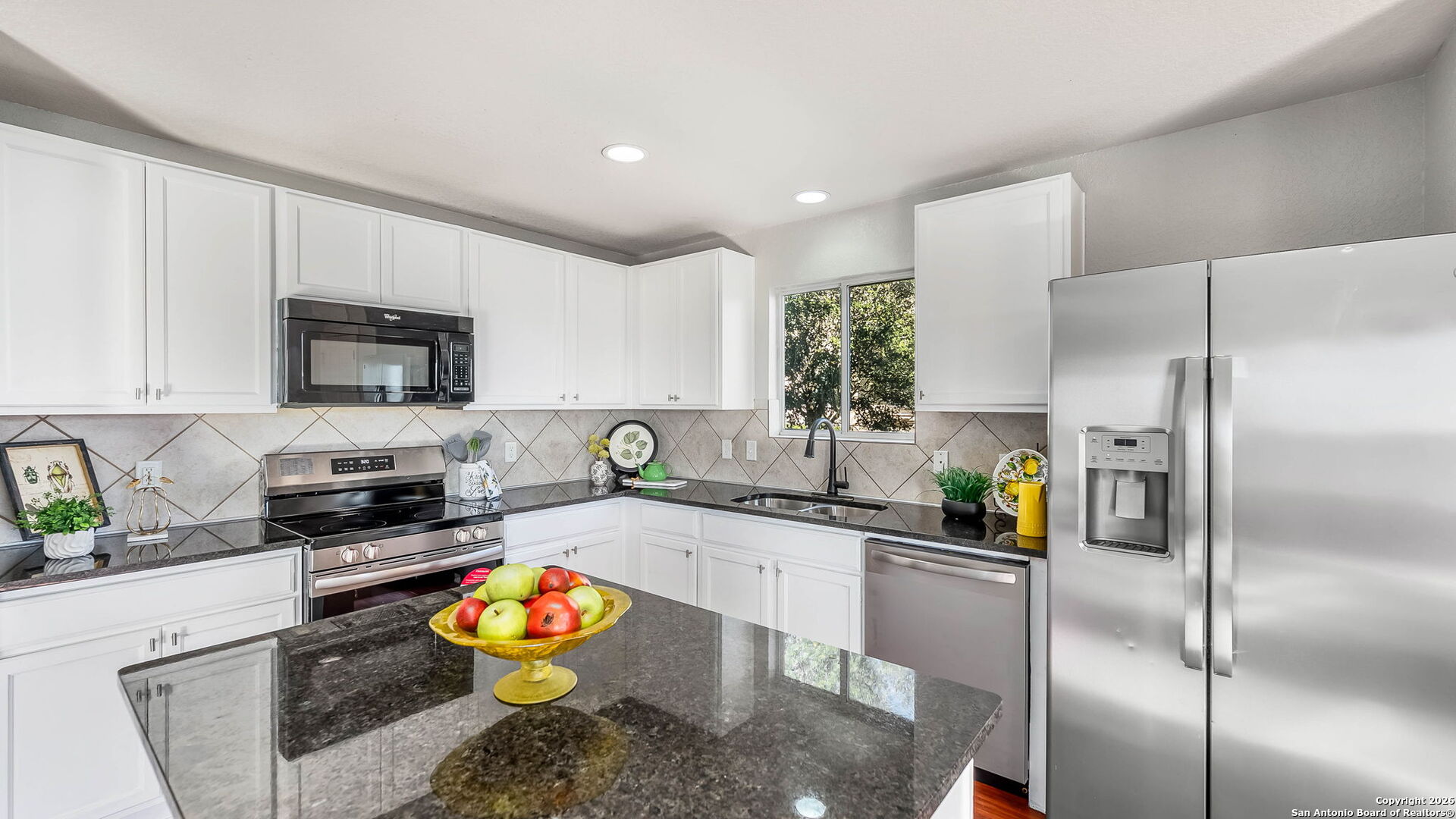 7690 Paraiso Boerne, TX 78015 - Photo 7 of 21 a kitchen with stainless steel appliances granite countertop a refrigerator a stove and a sink