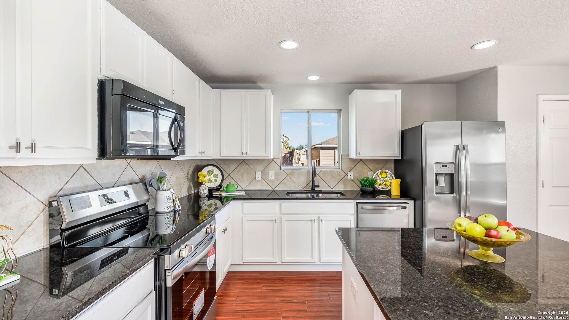 7690 Paraiso Boerne, TX 78015 - Photo 9 of 24 a kitchen with stainless steel appliances granite countertop a stove top oven a sink and cabinets