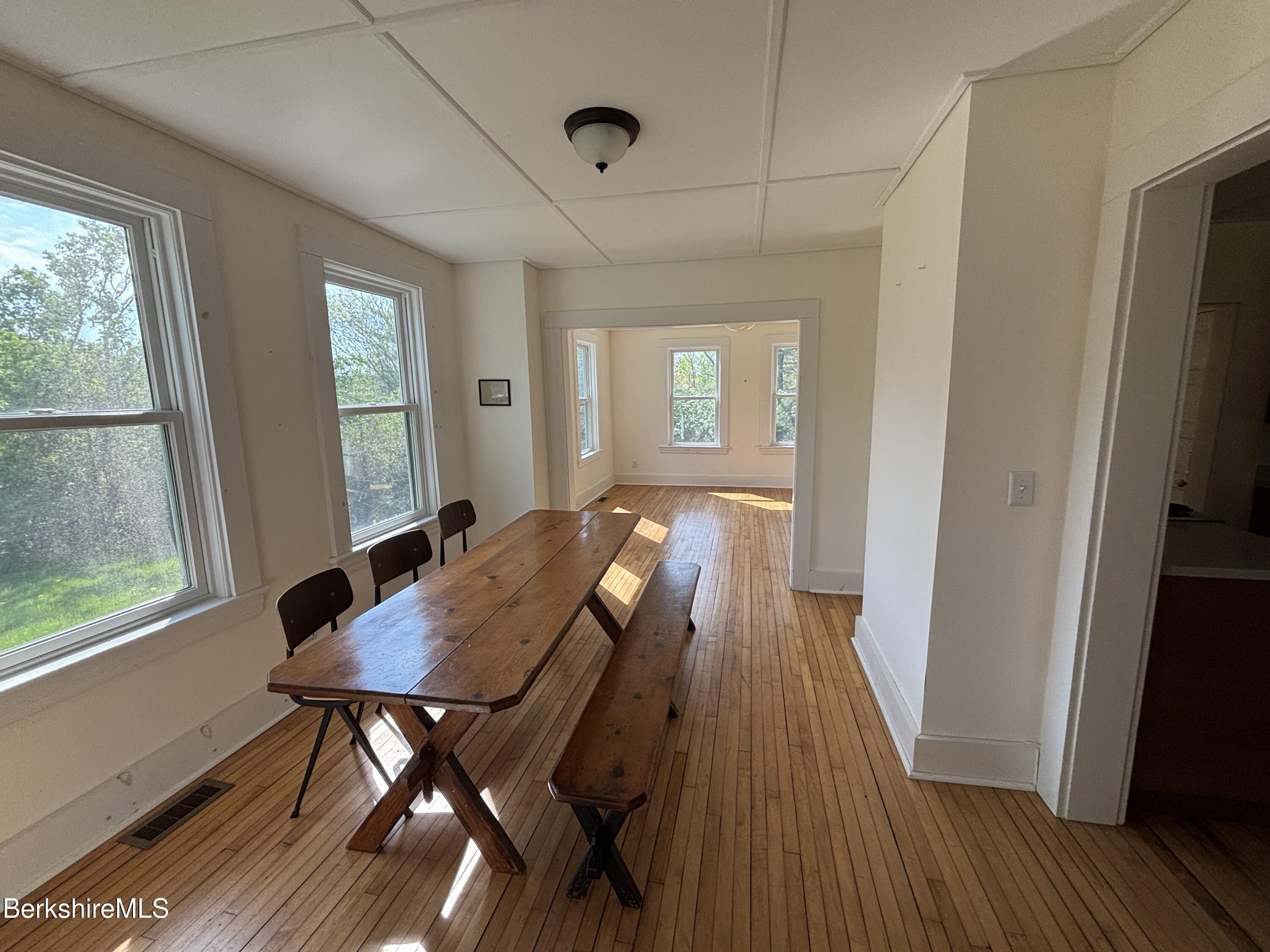 86 Miner Road Lanesborough, MA 01237 - Photo 29 of 44 a view of a dining room with furniture window and wooden floor