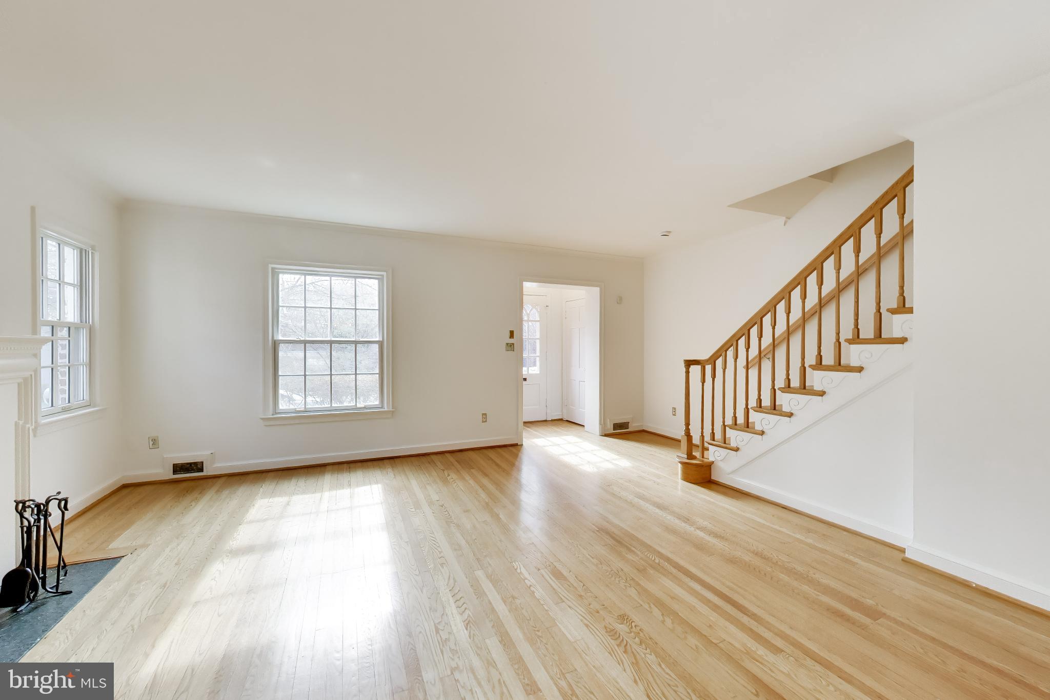 5138 Nebraska Avenue Northwest Washington, DC 20008 - Photo 4 of 39 a view of an empty room with wooden floor and a window