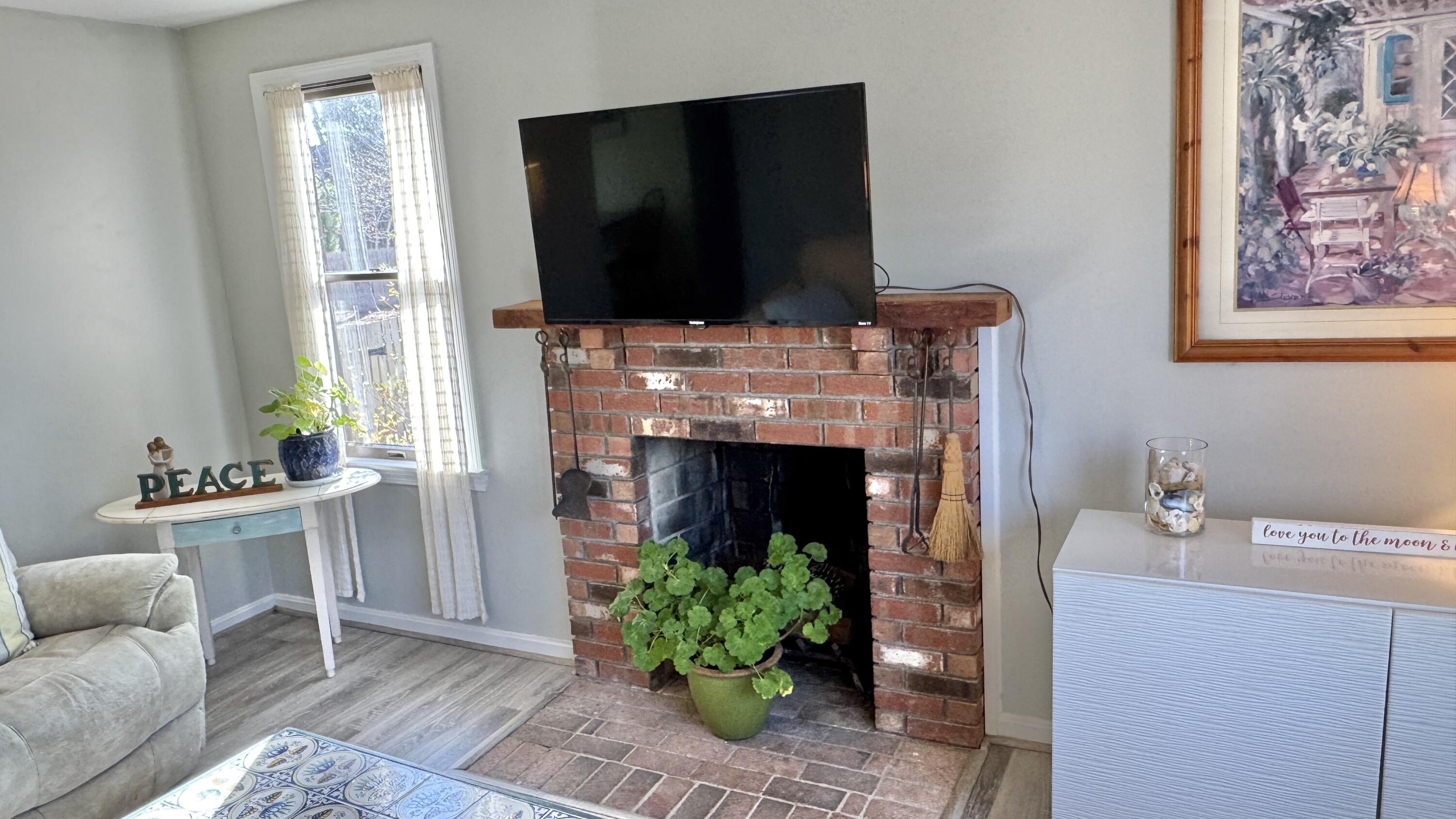 300 Brackett Road Eastham, MA 02642 - Photo 16 of 30 a living room with furniture a flat screen tv and a fireplace