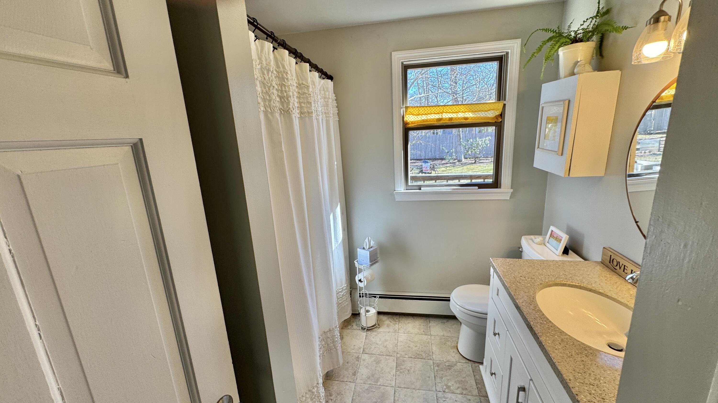 300 Brackett Road Eastham, MA 02642 - Photo 18 of 30 a bathroom with a tub sink and mirror