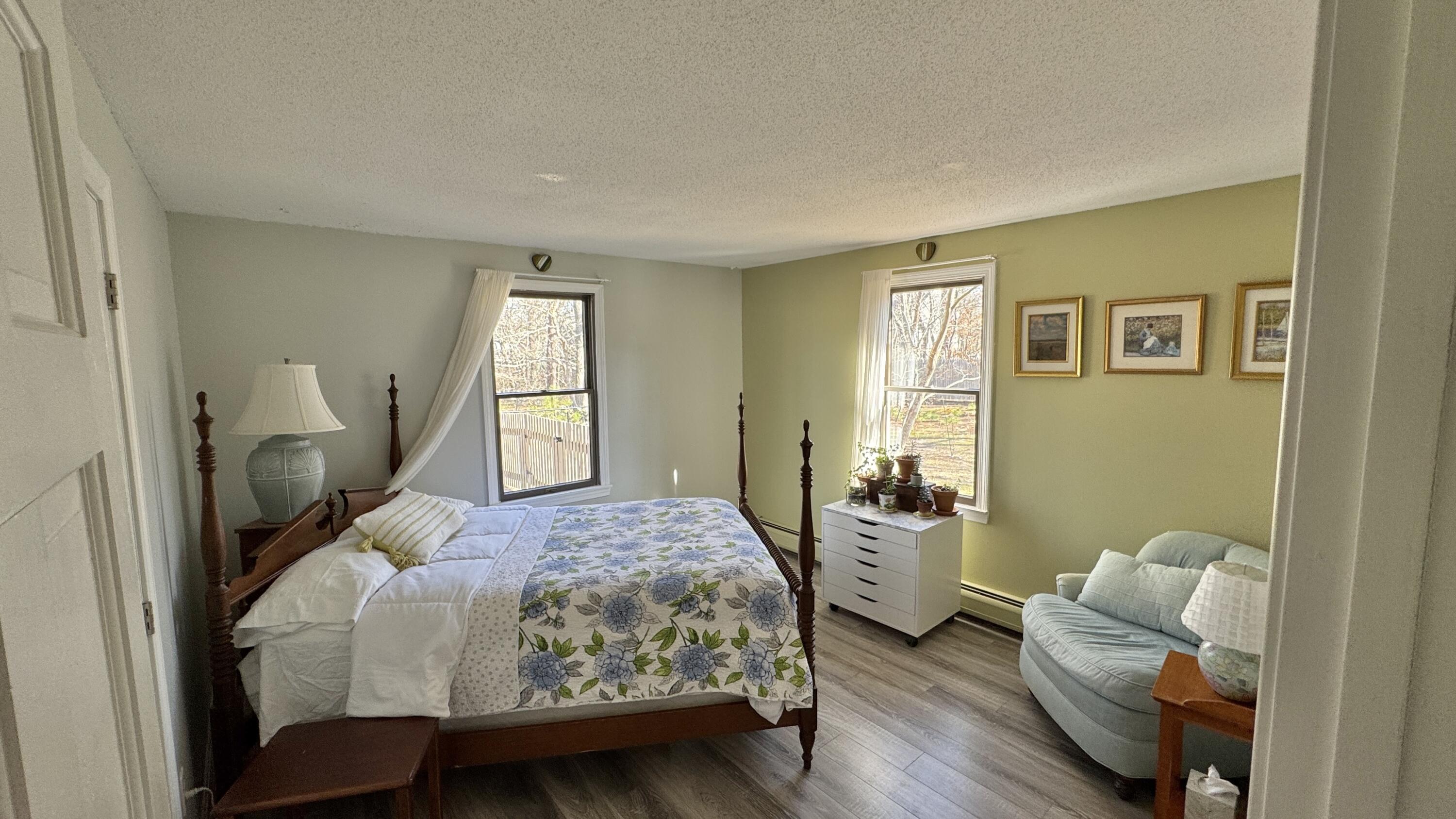 300 Brackett Road Eastham, MA 02642 - Photo 21 of 30 a bedroom with a bed and wooden floor