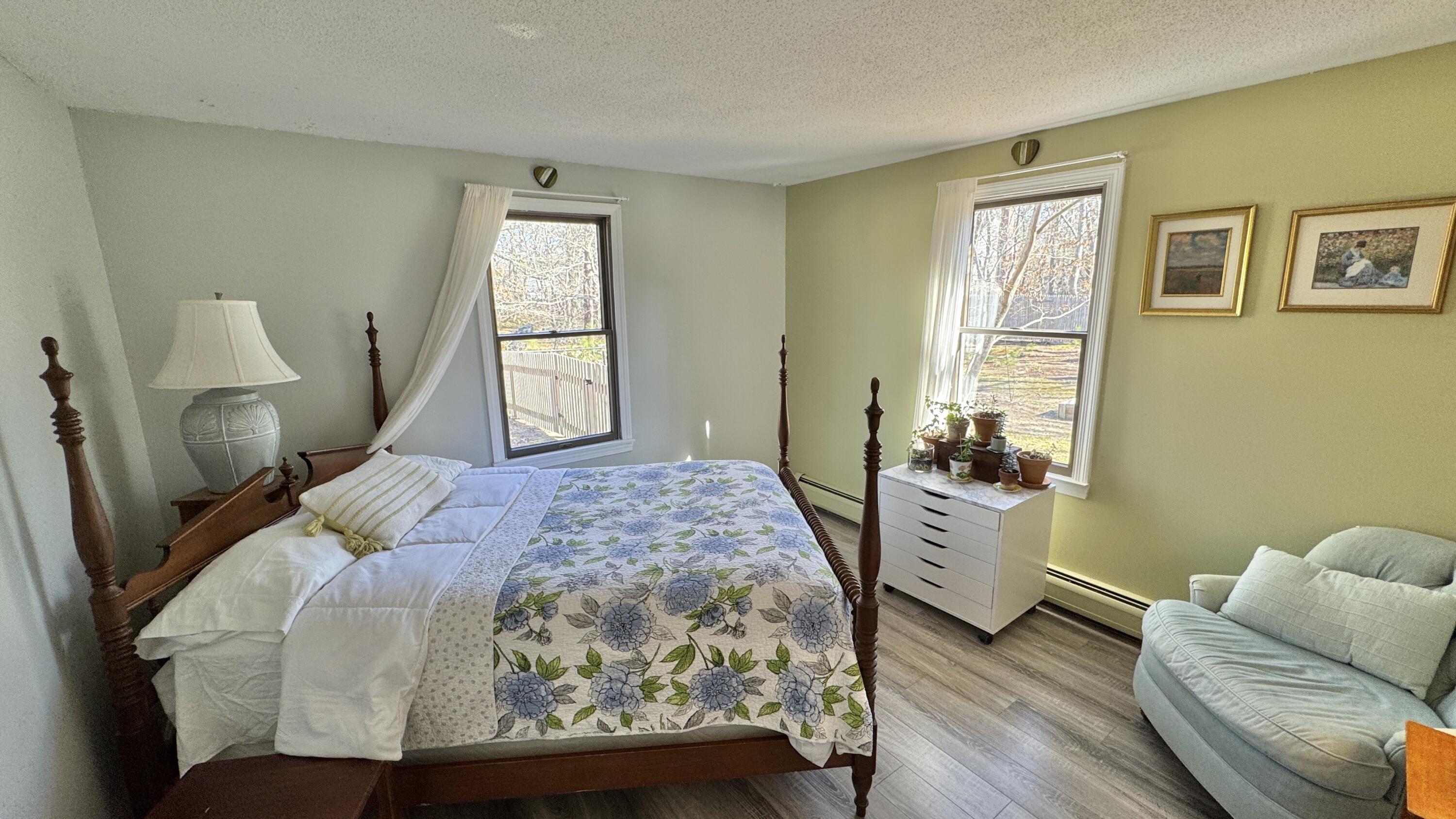 300 Brackett Road Eastham, MA 02642 - Photo 24 of 30 a bedroom with a bed and wooden floor