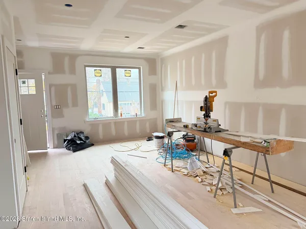 a room with furniture a rug and a window