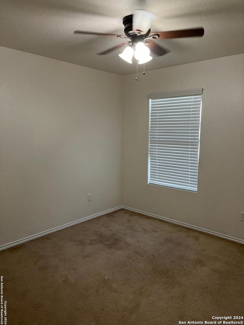 803 Roping Horse San Antonio, TX 78260 - Photo 13 of 18 an empty room with a window and a fan