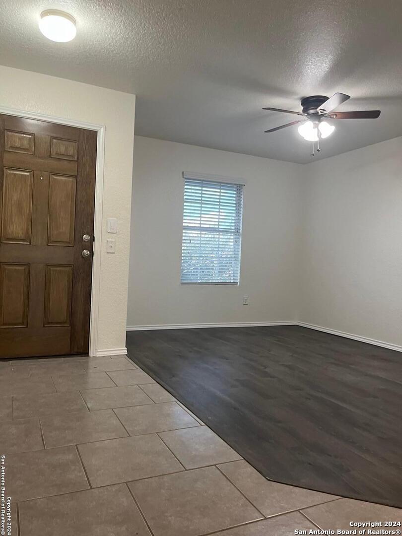 803 Roping Horse San Antonio, TX 78260 - Photo 2 of 18 an empty room with wooden floor cabinet and windows