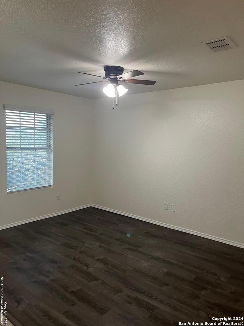 803 Roping Horse San Antonio, TX 78260 - Photo 3 of 18 a view of empty room with wooden floor and fan