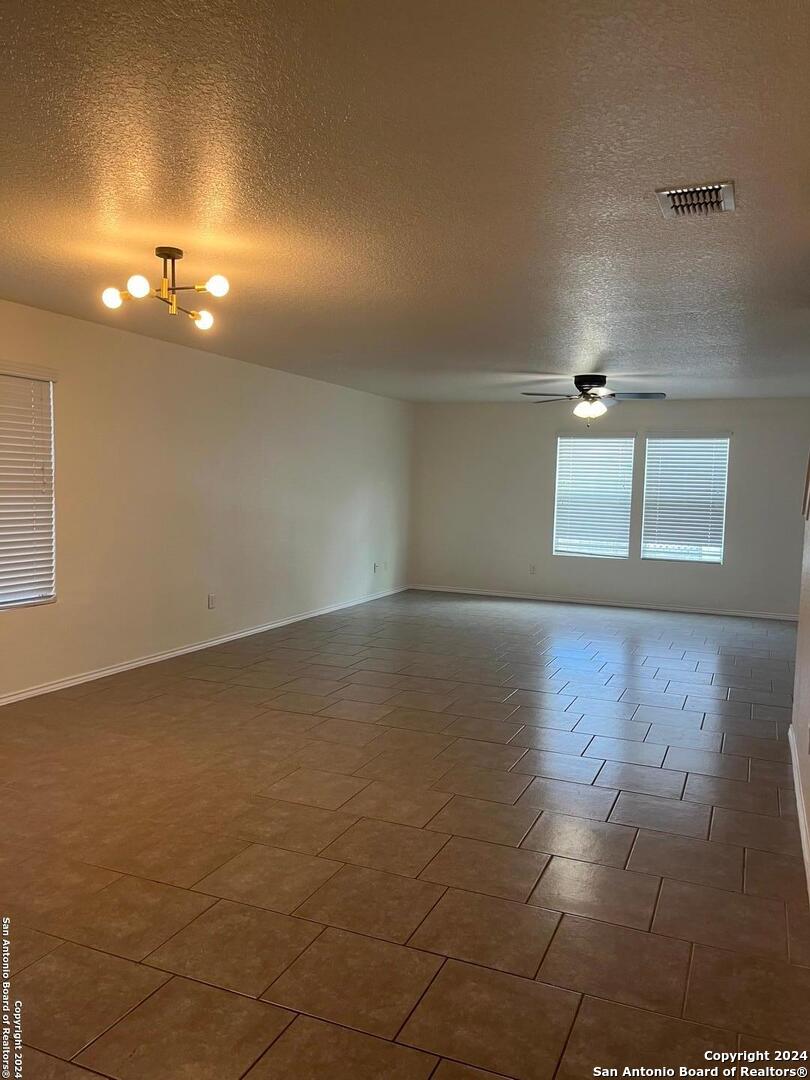 803 Roping Horse San Antonio, TX 78260 - Photo 4 of 18 an empty room with wooden floor and windows