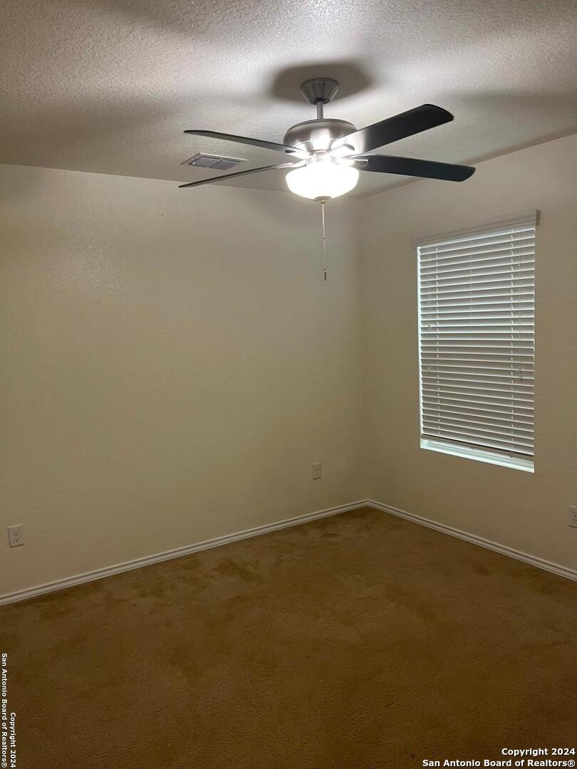 803 Roping Horse San Antonio, TX 78260 - Photo 6 of 18 a view of a room with chandelier fan and windows