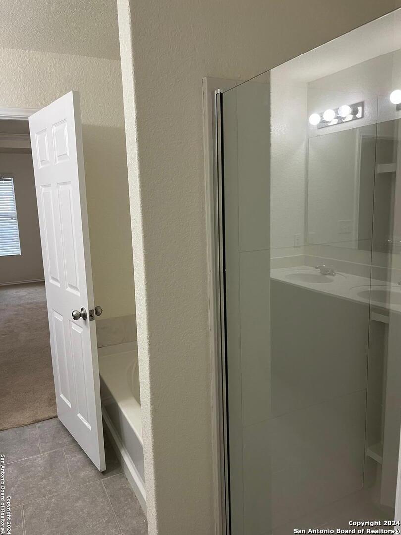 803 Roping Horse San Antonio, TX 78260 - Photo 8 of 18 a bathroom with a mirror and a shower