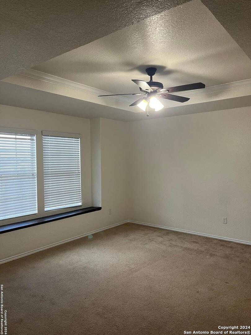 803 Roping Horse San Antonio, TX 78260 - Photo 9 of 18 an empty room with a chandelier fan and windows